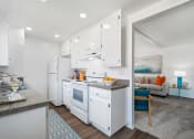 Thumbnail 9 of 40 - a kitchen with white cabinets and a counter top and a white refrigerator