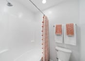 Thumbnail 13 of 40 - a bathroom with a shower and a toilet and a shower curtain