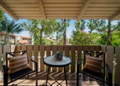 Thumbnail 15 of 40 - a patio with two chairs and a table on a balcony