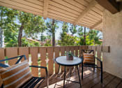 Thumbnail 34 of 40 - a balcony with two chairs and a table