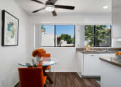 Thumbnail 7 of 40 - a kitchen and dining room with a large window and a ceiling fan