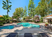 Thumbnail 20 of 40 - a swimming pool with chairs and umbrellas next to a resort style pool