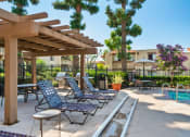 Thumbnail 19 of 40 - a patio with lounge chairs and a swimming pool
