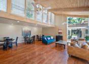 Thumbnail 31 of 40 - a spacious living room with a ceiling fan and a dining room table