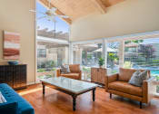 Thumbnail 29 of 40 - a living room with couches and chairs and a coffee table