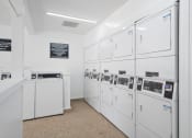 Thumbnail 36 of 40 - the laundry room is equipped with washer and dryer machines