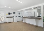 Thumbnail 38 of 40 - a kitchen with white cabinets and counters and a counter top