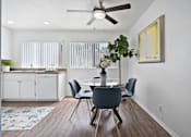 Thumbnail 11 of 36 - a dining room with a table and chairs and a ceiling fan