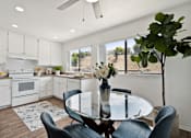 Thumbnail 10 of 36 - an open kitchen and dining area with a glass table and chairs