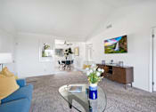 Thumbnail 5 of 36 - a living room with a blue couch and a glass coffee table
