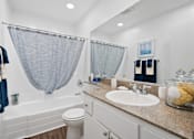Thumbnail 15 of 36 - a bathroom with a sink and a toilet and a tub