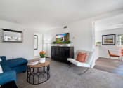 Thumbnail 20 of 38 - a living room with a blue couch and a white chair