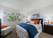 Thumbnail 27 of 38 - a bedroom with a large bed and a window