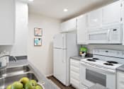 Thumbnail 14 of 49 - a kitchen with white appliances and a sink