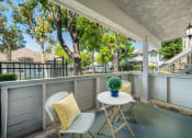 Thumbnail 18 of 38 - a patio with two chairs and a table on a balcony