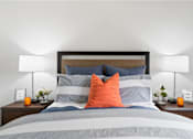 Thumbnail 8 of 49 - a bedroom with a bed with blue and orange pillows