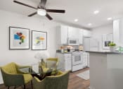 Thumbnail 6 of 38 - an open kitchen and dining area with a glass table and chairs