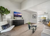 Thumbnail 7 of 35 - the living room of an apartment with a couch and a table