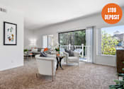 Thumbnail 1 of 60 - A living room with a white sofa and a painting on the wall.