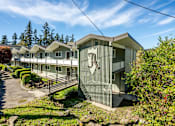 Thumbnail 1 of 14 - A row of houses with a stone wall in front.