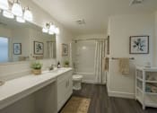 Thumbnail 5 of 11 - A bathroom with a white counter and a white toilet.