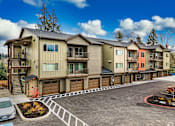 Thumbnail 13 of 24 - A row of townhouses with a car parked in front of the first one.