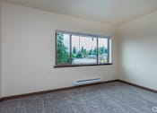 Thumbnail 17 of 24 - A room with a window overlooking a street.