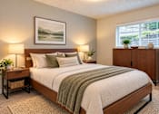 Thumbnail 6 of 13 - A bedroom with a large bed and a painting on the wall.