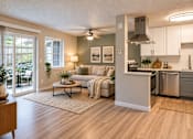 Thumbnail 5 of 13 - A modern kitchen with a dining table and chairs.