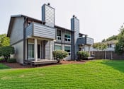 Thumbnail 17 of 20 - A modern house with a grey exterior and a well-maintained lawn.