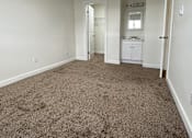 Thumbnail 13 of 16 - A room with carpeted floor and white walls.