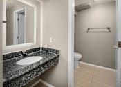 Thumbnail 8 of 21 - A bathroom with a sink and toilet.
