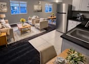 Thumbnail 11 of 21 - A modern kitchen with a dining table set for two.