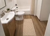 Thumbnail 3 of 16 - A small bathroom with a sink, toilet, and bathtub.