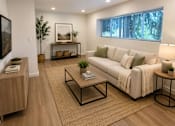 Thumbnail 1 of 16 - A modern living room with a white sofa and a wooden floor.