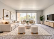Thumbnail 10 of 14 - A modern living room with a white sofa, a coffee table, and a television.