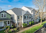 Thumbnail 16 of 16 - A row of houses with a car parked in front of the last one.