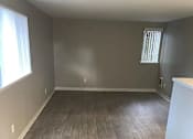 Thumbnail 7 of 13 - A room with wooden flooring and a window.