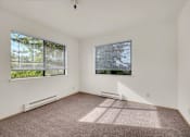 Thumbnail 10 of 14 - A room with a window and a wall-mounted air conditioner.