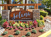Thumbnail 18 of 18 - A sign that says "solana apartments" in front of a building.