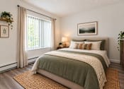 Thumbnail 8 of 18 - A bedroom with a large bed and a window with curtains.