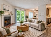 Thumbnail 1 of 18 - A living room with a fireplace and a couch.