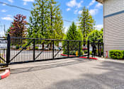 Thumbnail 17 of 18 - A black metal gate with a sign that reads "No Trespassing" is blocking the entrance to a driveway.