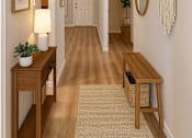 Thumbnail 3 of 18 - A hallway with a rug and a hanging decoration.