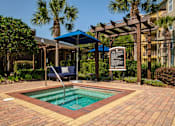 Thumbnail 35 of 42 - a small pool in a courtyard with a sign and a chair