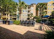 Thumbnail 33 of 42 - a patio with tables and chairs in front of an apartment building