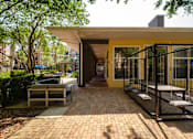 Thumbnail 32 of 42 - a patio with benches and a building in the background