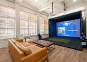 Thumbnail 31 of 42 - a living room with a projector screen and a couch