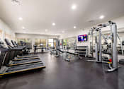 Thumbnail 19 of 42 - the gym is equipped with cardio equipment and weights