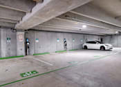 Thumbnail 37 of 42 - a white car parked in a parking garage